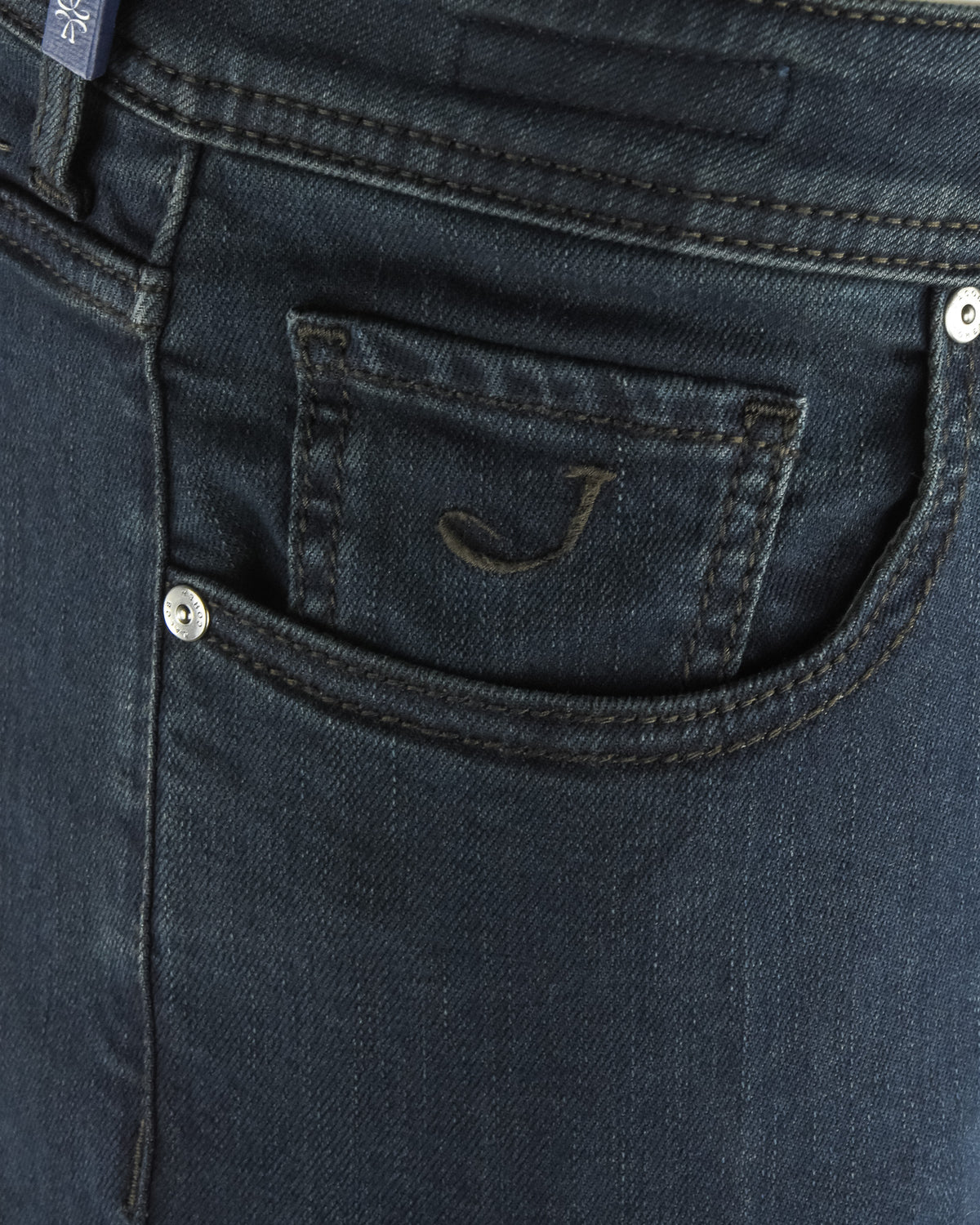 Dark blue denim jeans coin pocket and belt loops with metal button detail.