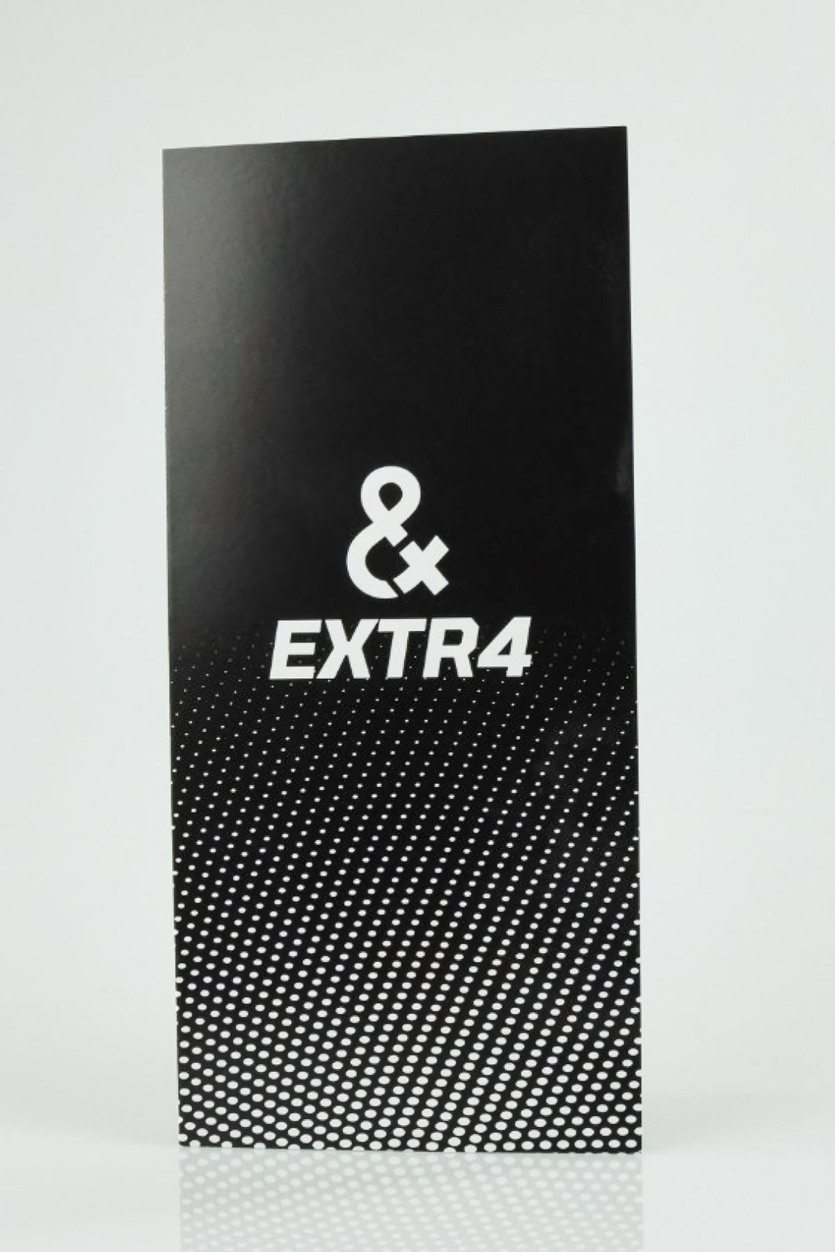 Black EXTR4 product bag with white & EXTR4 logo and dotted bottom pattern