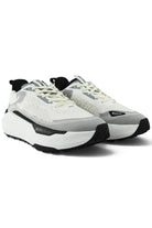 Pair of white and gray waterproof runners with light green laces and black trims