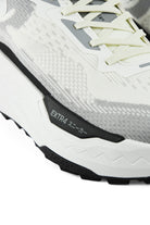 Side view detail of white and gray waterproof running shoe with black trim
