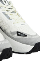 Close-up of white and gray waterproof shoe with GORE-TEX Infinity Wear label