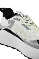 Angled view of white and gray waterproof running shoes with light green lace system