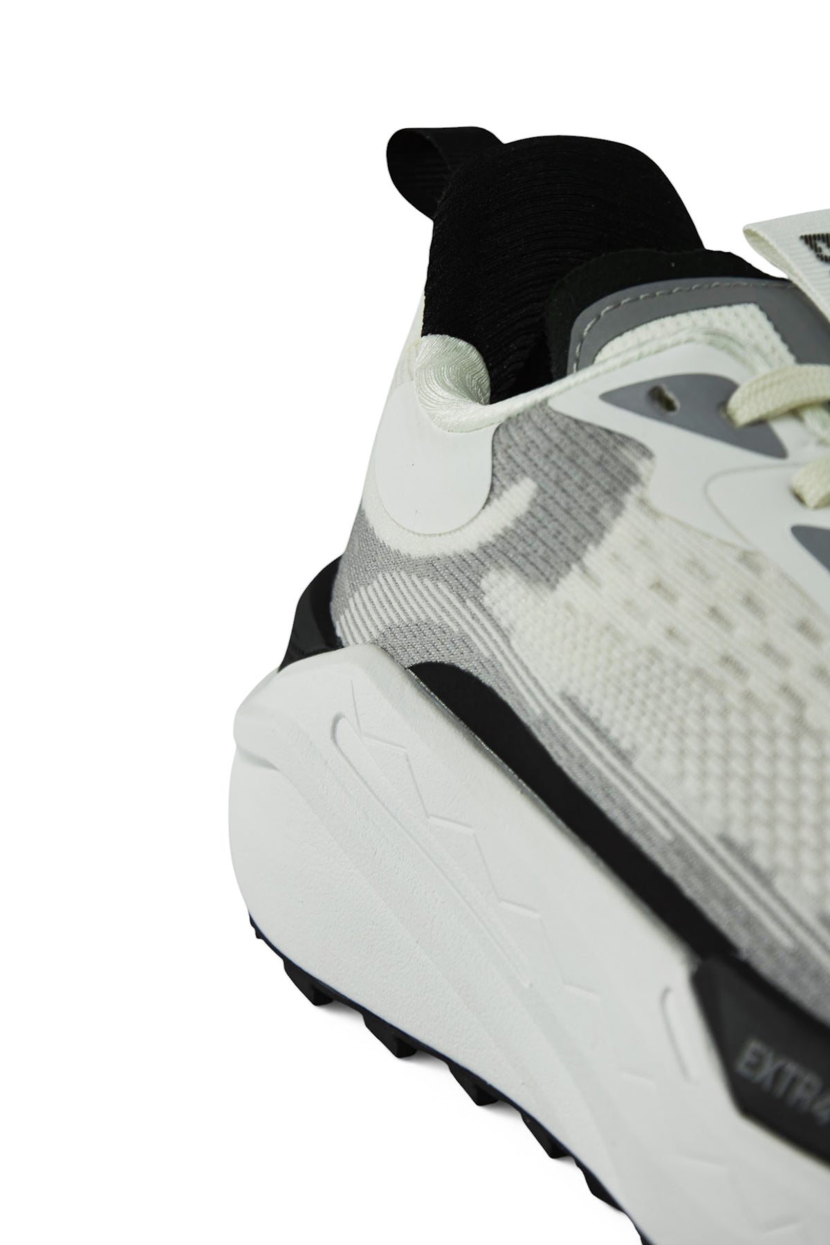 White-pearl waterproof running sneaker with black heel collar, textured outsole
