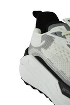 White-pearl waterproof running sneaker with black heel collar, textured outsole