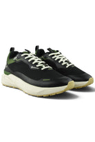 Waterproof GTX running shoe angled view in black with green panels and white laces
