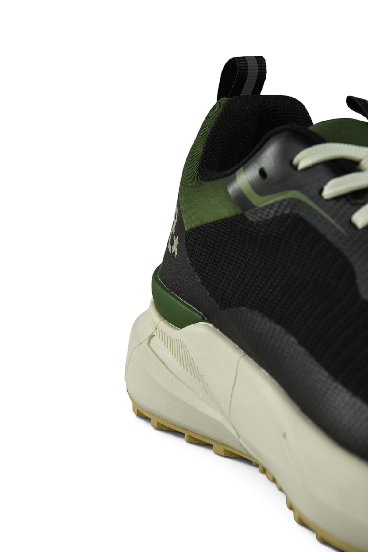 Waterproof GTX running shoe close-up of side panel, black mesh with green accents