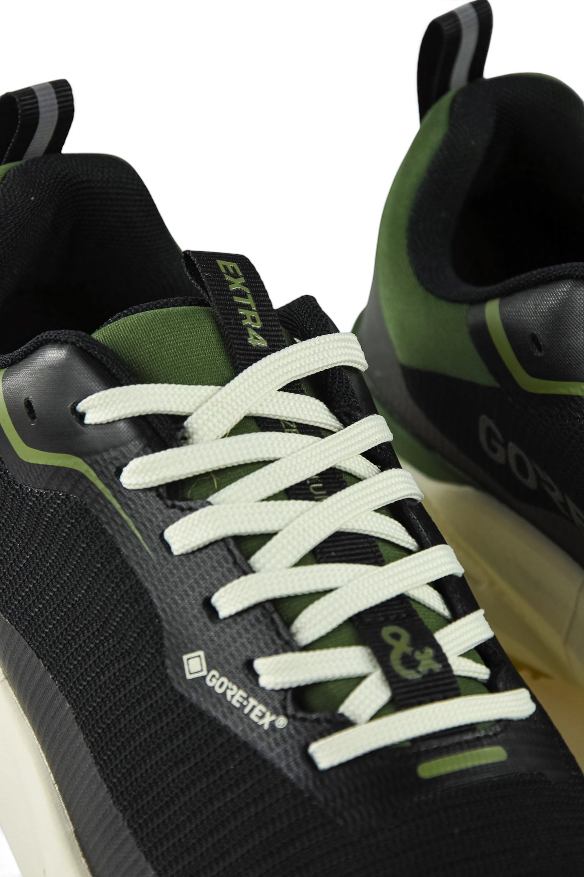 Waterproof GTX running shoe lace and side logo close-up in black with green trim