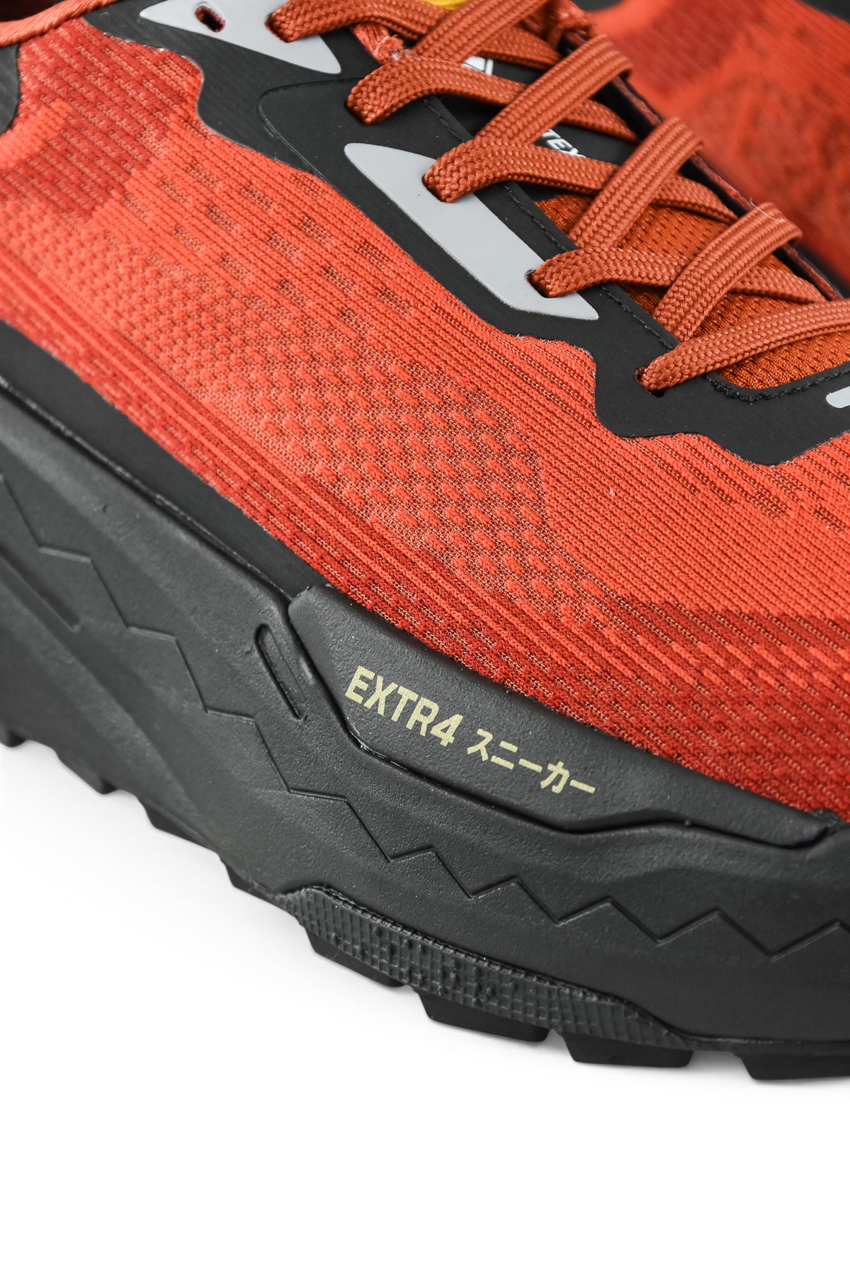 Rust orange upper and black midsole with EXTRA branding on textured outsole