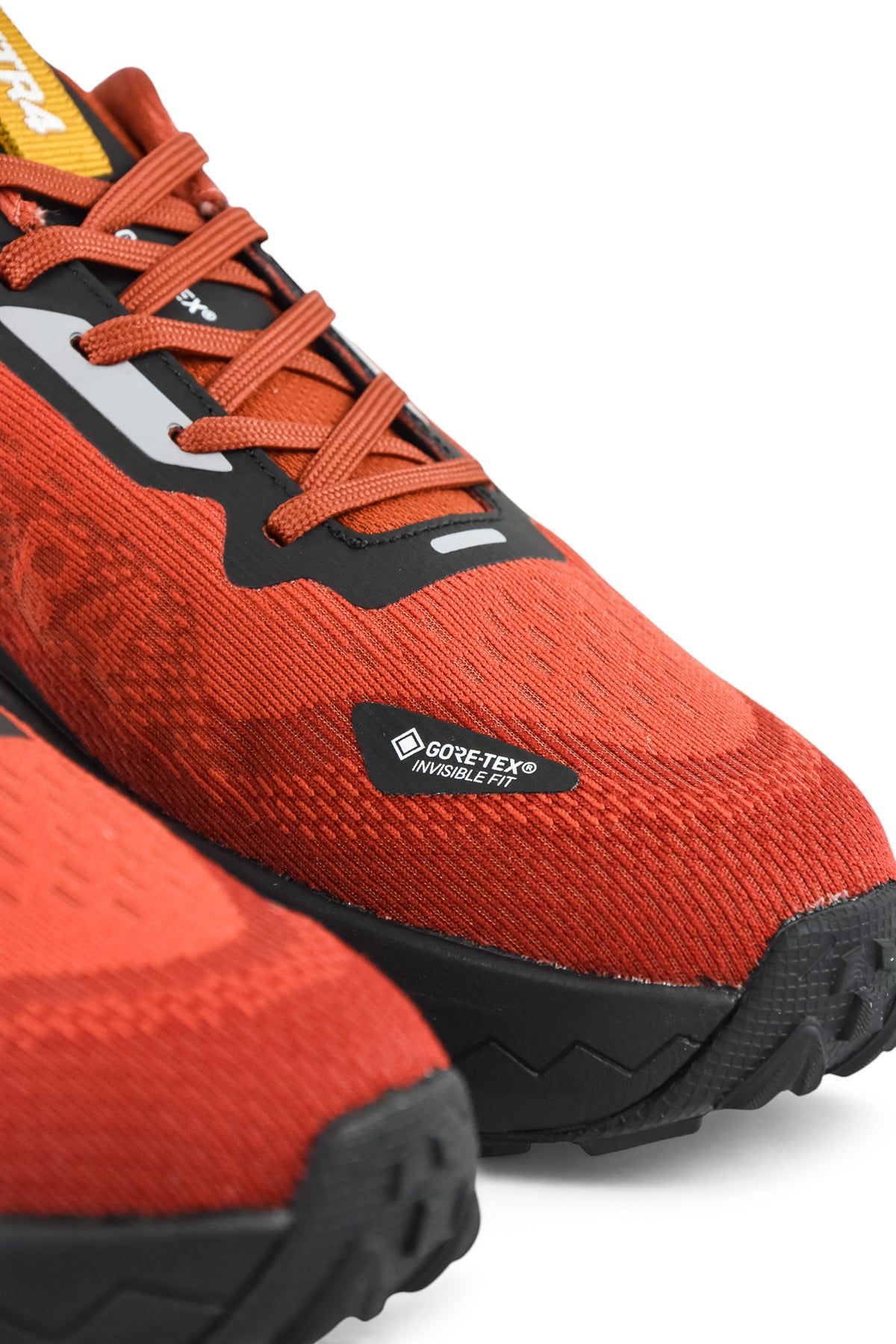 Rust orange waterproof running shoe with black trim and Gore-Tex Waterproof logo badge
