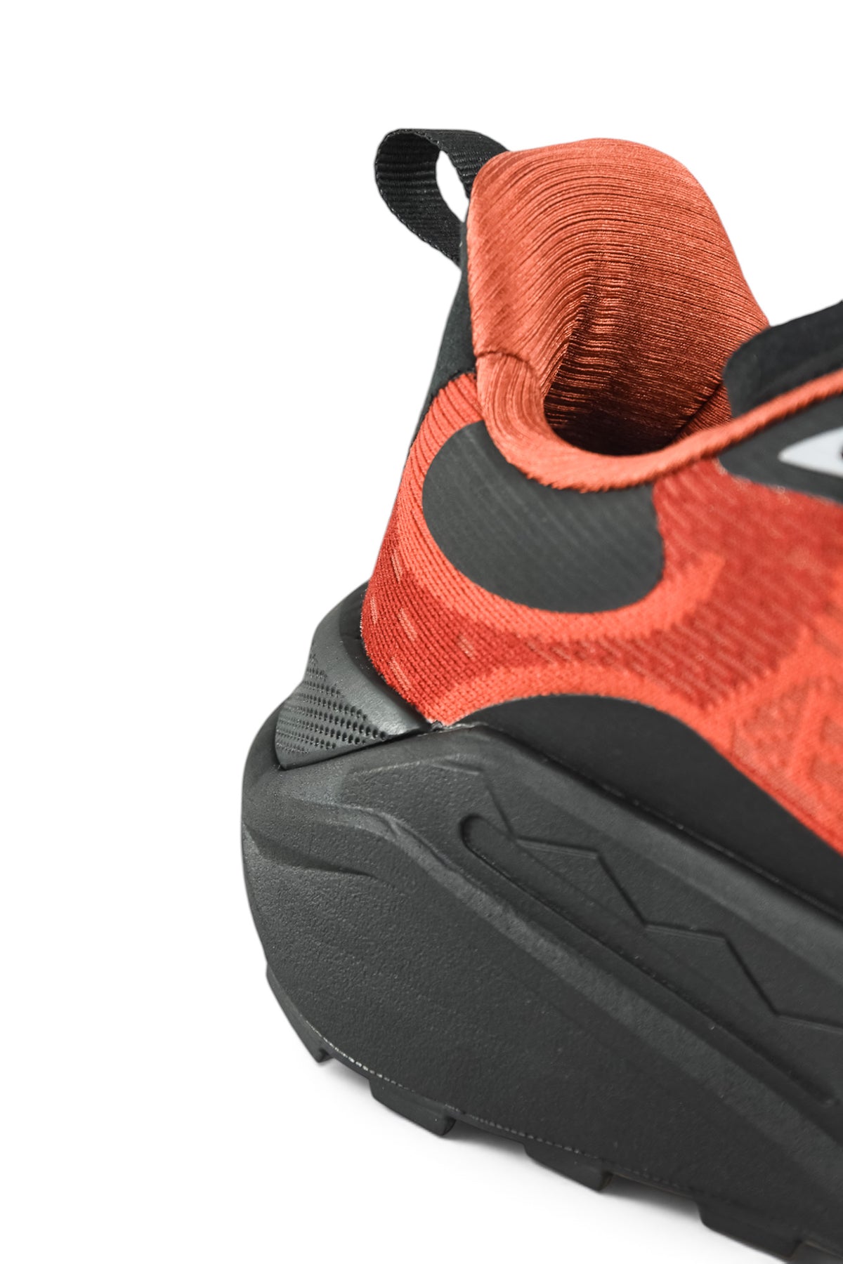 Rust orange runner shoe showing black heel collar and treaded outsole