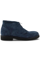 Navy suede chukka boot with lace-up design and dark rubber sole