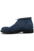 Navy suede chukka boot, back/side view with lace-up and low profile sole