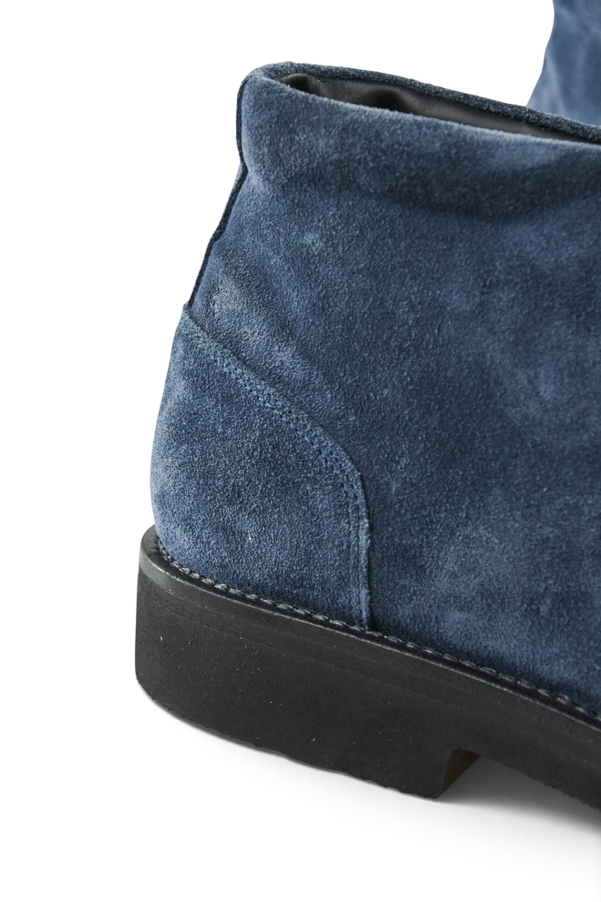 Navy suede chukka boot close-up of ankle collar and dark rubber sole