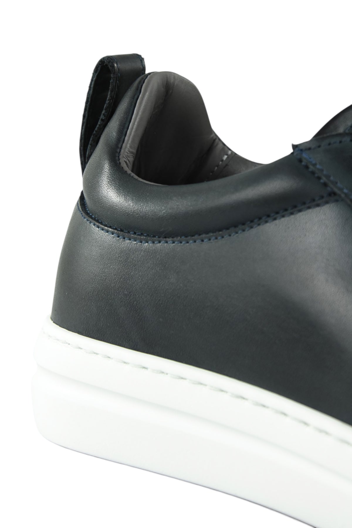 Navy leather low-top sneaker heel with padded collar and white rubber midsole.