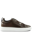 Brown leather low-top trainer with lace-up, white midsole, and rubber cup sole