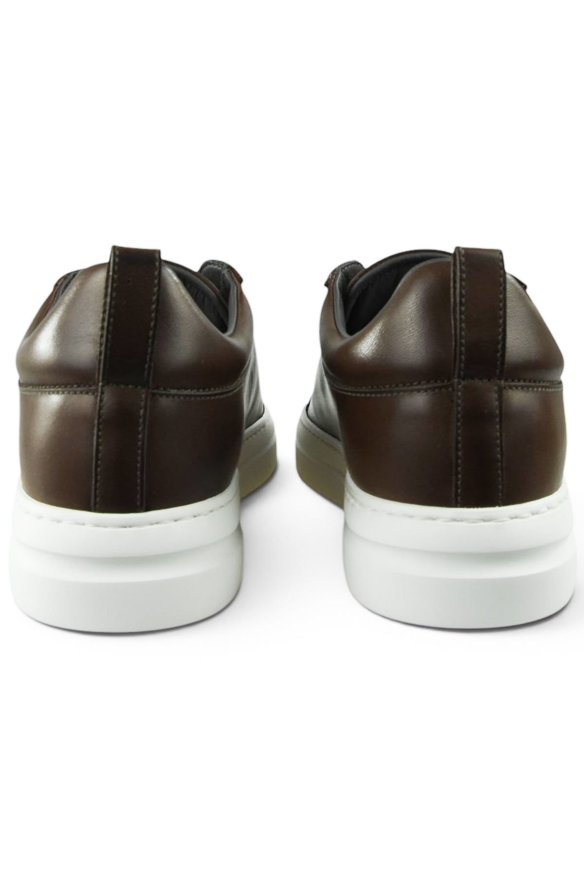 Back view of brown leather low-top trainers with white soles and padded collars