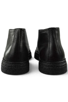 Back view of black leather lace-up ankle boots showing heel and textured sole edge.