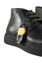 Black leather ankle boots with lace-up closure and rugged textured platform sole