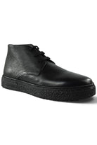 Black leather lace-up desert boot with low ankle height and grippy sole.