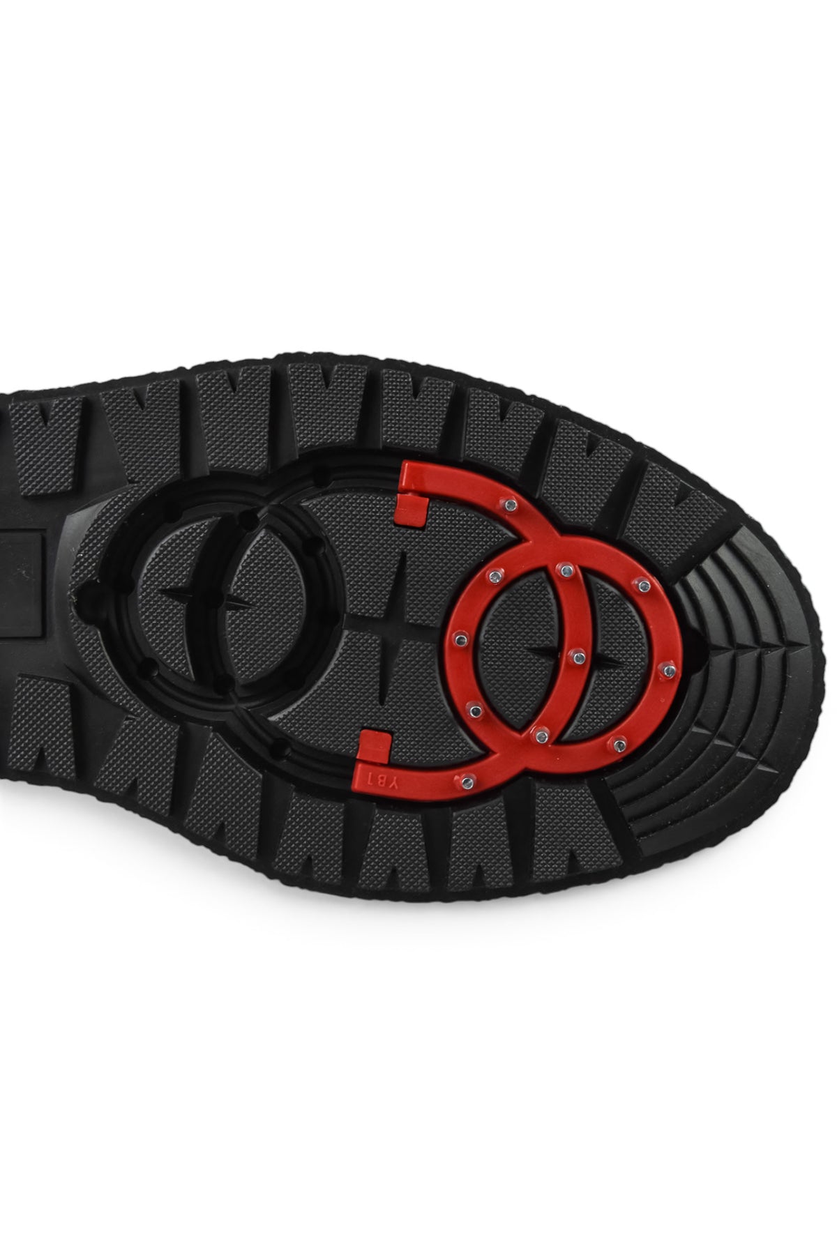 Black ankle boot outsole tread with red and circular grip design