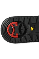 Black outsole tread with red circular grip plate and yellow arrow detail
