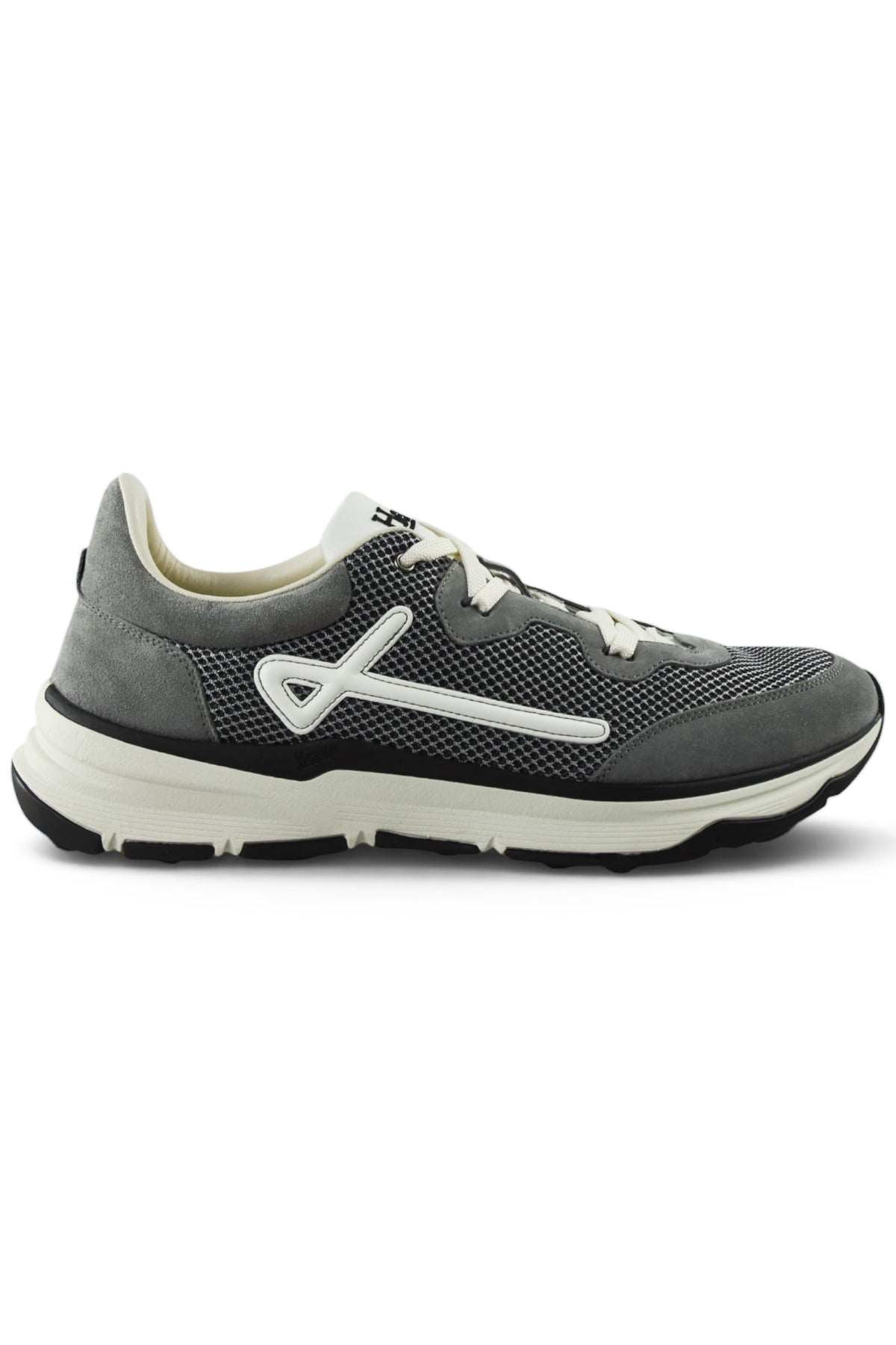 Grey trainers side view with white trim, lace-up front, and grippy black sole