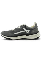 Grey trainers front-left angle with white laces, logo accents, and layered sole