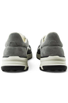 Grey trainers rear view with cushioned collar, heel panel, and white midsole
