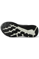 Black trainer outsole with raised traction lugs and light tread pattern