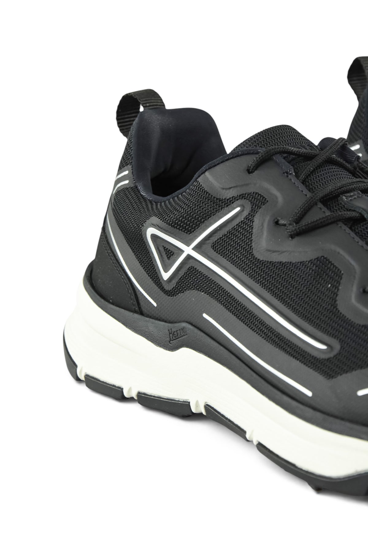 Close-up of black mesh trainer upper with lace eyelets and reflective side stripe