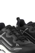 Close-up of black lace-up mesh trainers with side logo and white accent midsole