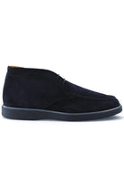 Blue suede chukka desert boots with lace-up closure and dark rubber sole.