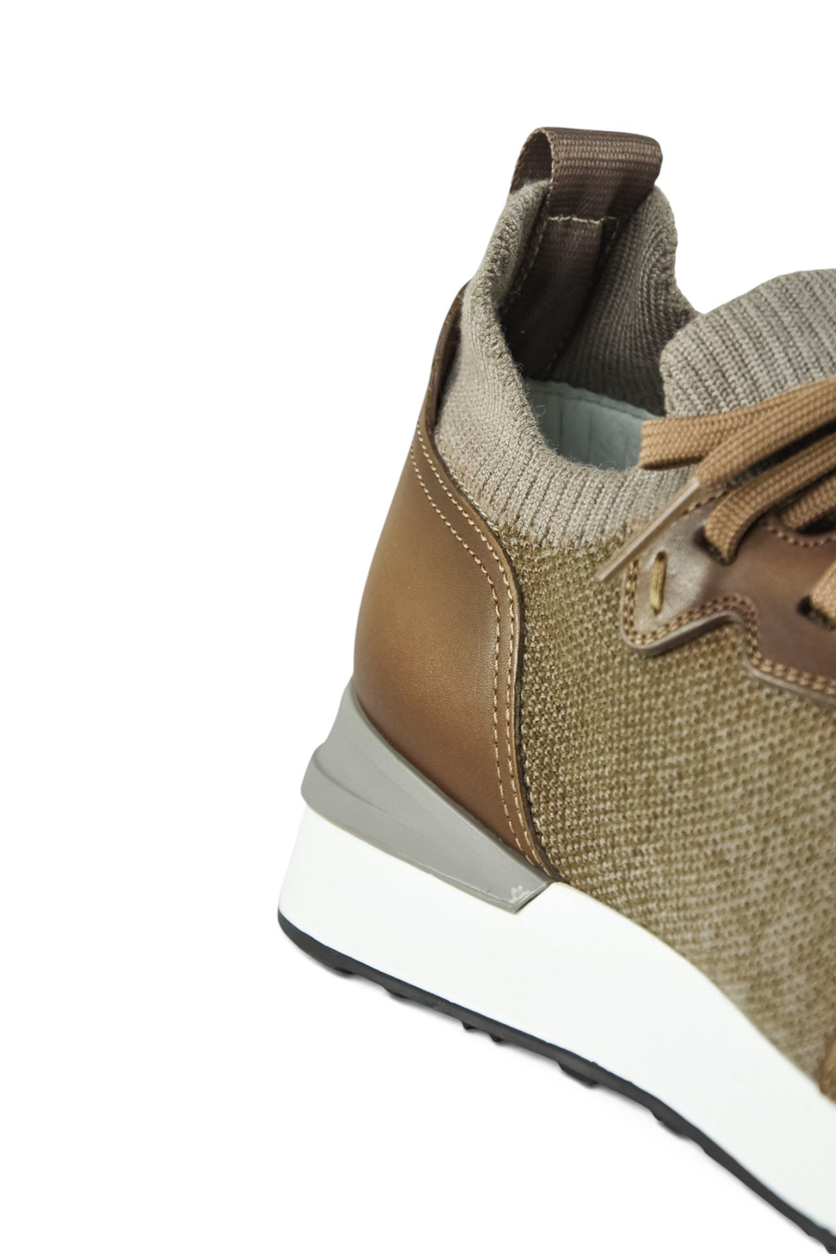Side close-up of tan knit and leather trainer with elastic collar and white midsole