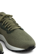 Close-up of khaki knit lace-up sneaker with textured toe and dark lace eyelets