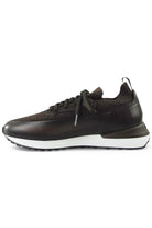 Dark brown low-top lace-up trainer with leather side panel and white sole.