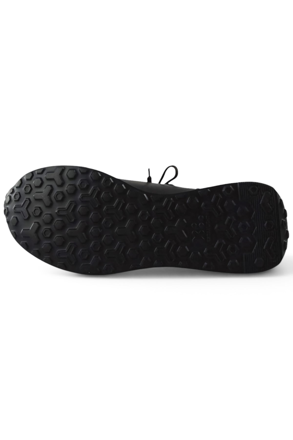 Trainer outsole view with textured rubber tread and rear heel profile.