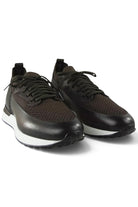 Pair of dark brown leather and knit lace-up trainers with white midsoles.