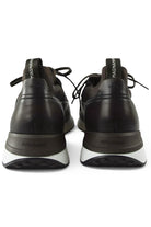 Back view of dark brown lace-up trainers with branded heel tabs and white soles.