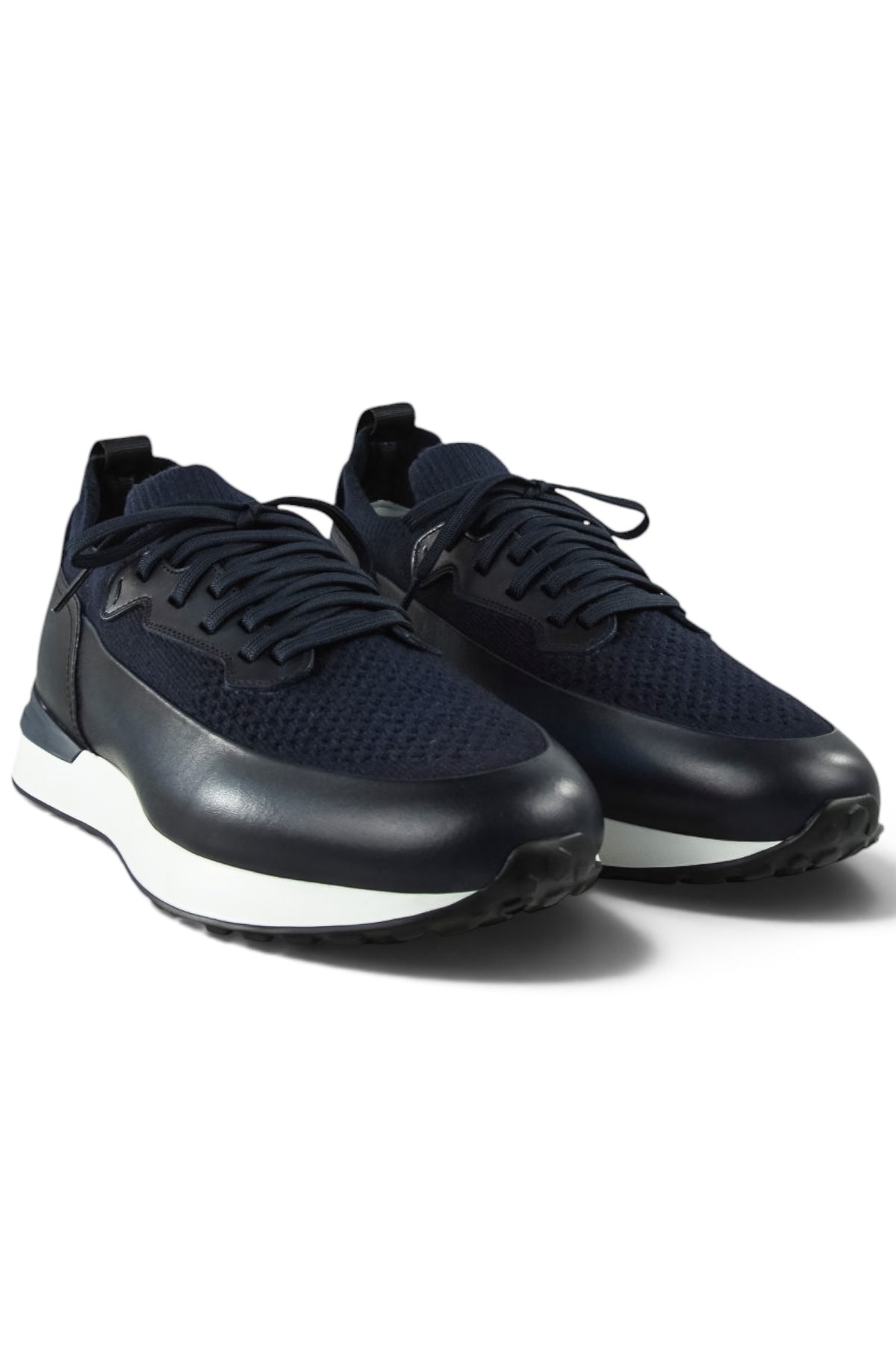 Pair of dark blue knitted and leather trainers with lace-up design and white rubber sole