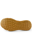 Gum rubber outsole for navy knitted trainer sneaker with textured grip studs
