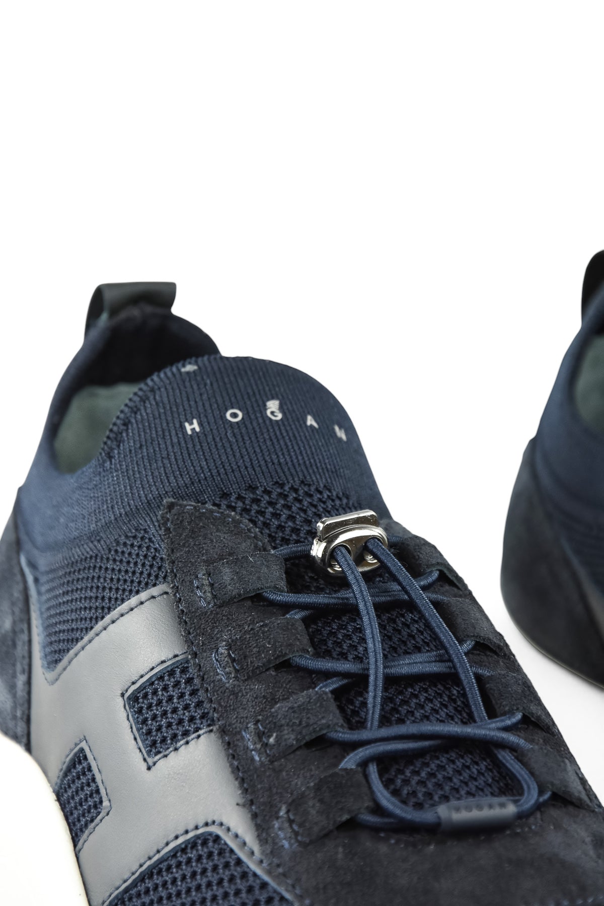 Navy knitted trainer sneaker tongue with lace-up eyelets and silver hook hardware