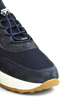 Navy knitted trainer sneaker side with perforated panel, laces, and suede trim