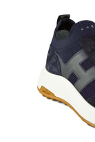 Navy lace-up trainer sneaker heel detail with logo patch and gum outsole