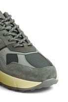 Close-up of grey trainer toe and lace area with perforations and treaded sole edge