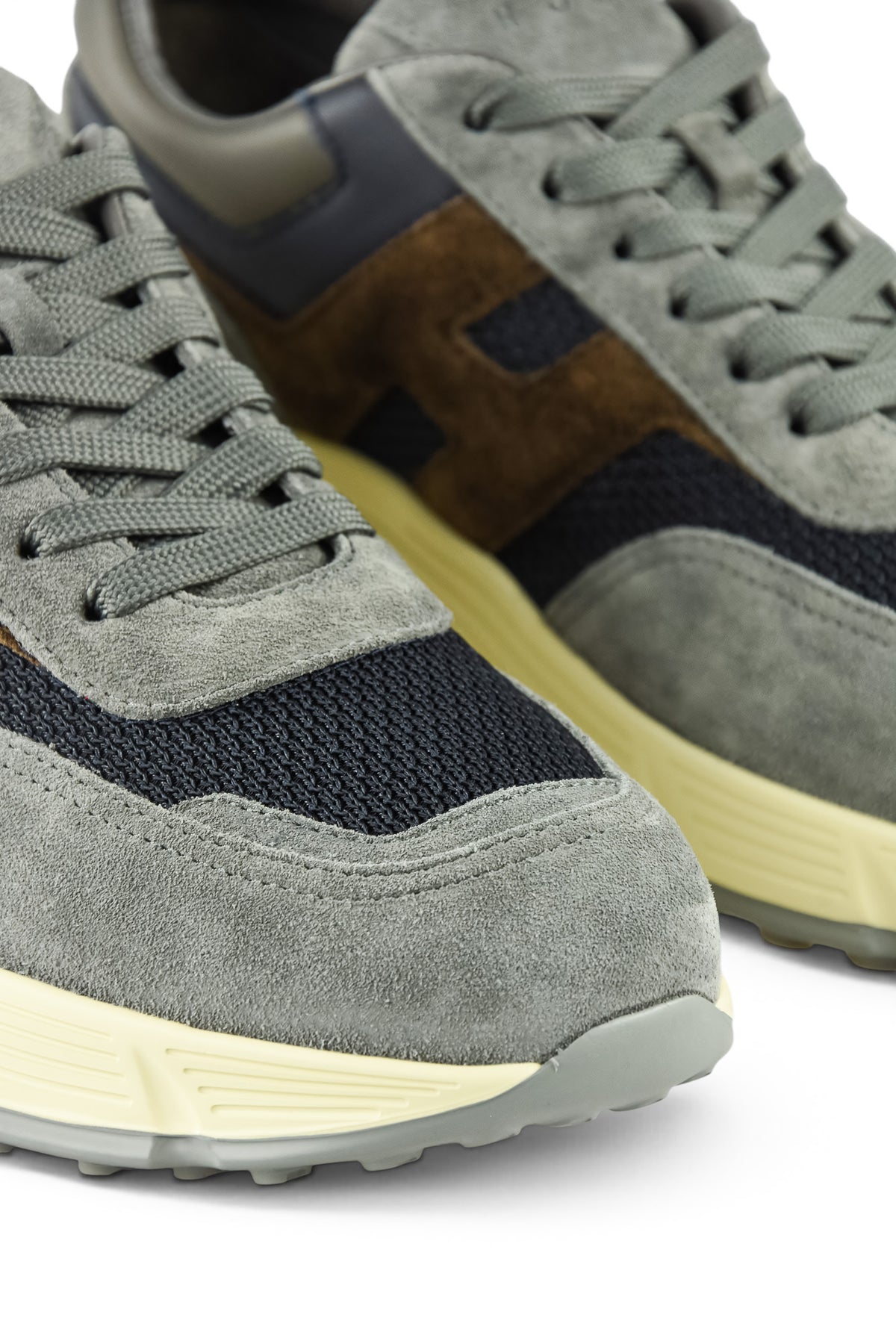 Hogan runner trainer toe and side close-up with grey suede and blue knit panels