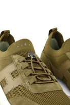 Khaki lace-up trainer with metal eyelets and perforated knit texture