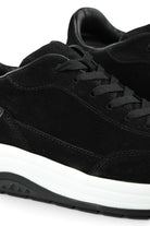 Close-up of black suede lace-up toe with contrast stitching and white midsole