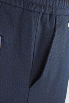 Navy textured jersey pants with front seam detail and slanted side pocket opening