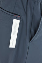 Steel grey stretch pants with side seam detail and interior label at thigh