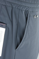Steel grey drawstring pants with interior pocket curve and brand label tab